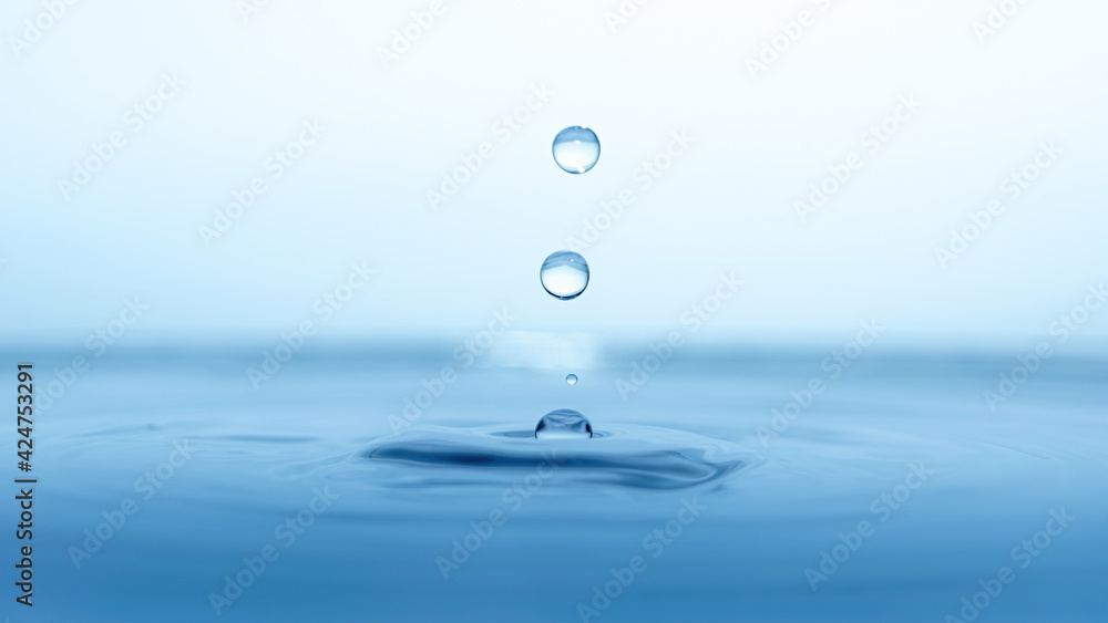 water drop splash in a glass blue colored water drop splash in a glass blue colored