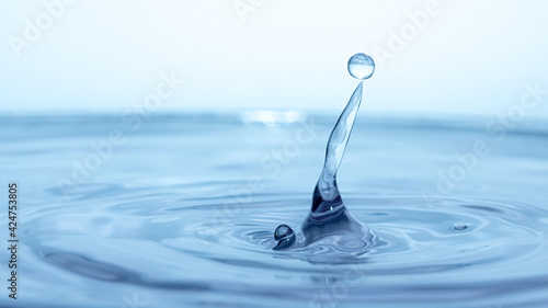 water drop splash in a glass blue colored