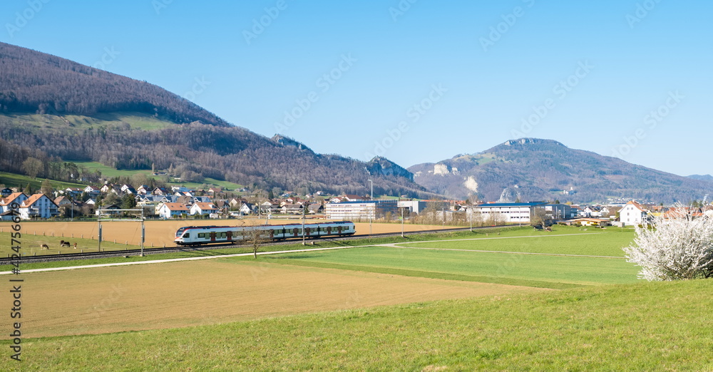 Obraz premium Swiss countryside landscape with a running train, Switzerland