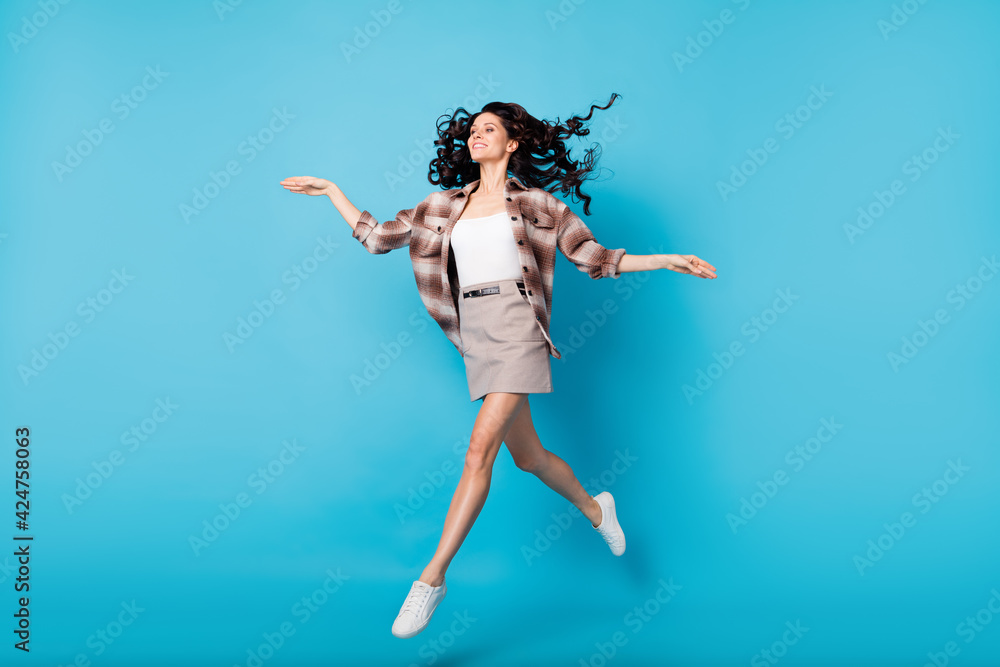 Photo of graceful pretty lady run dance look empty space wear plaid coat mini skirt shoes isolated blue background Photo of graceful pretty lady run dance look empty space wear plaid coat mini skirt shoes isolated blue background