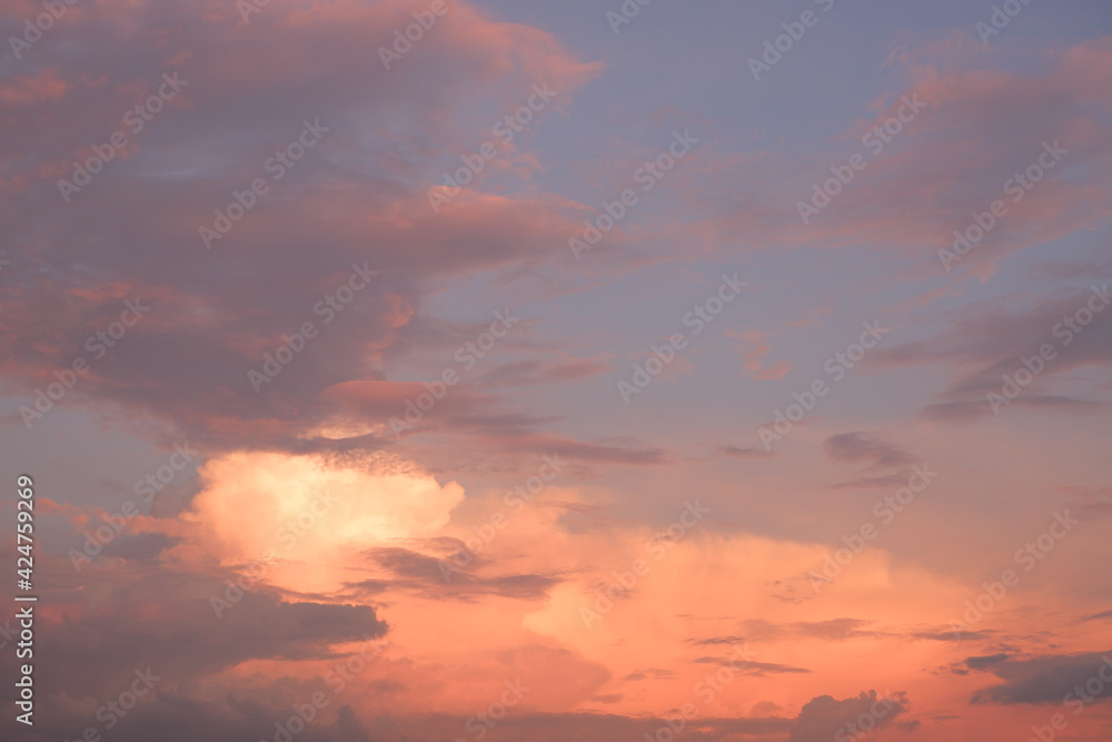 The sky at sunset before bad weather. Low red sunlight illuminates thunderclouds.