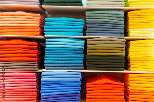 Shirts folded and sorted by colour ranges