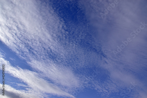 Cirrostratus clouds in the blue spring sky.