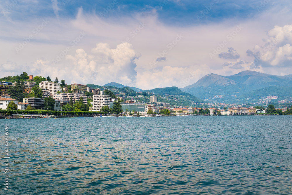 Big and modern Swiss city. Lugano city and Lugano lake in a beautiful summer day. Tourist town in southern Switzerland in the Canton of Ticino 