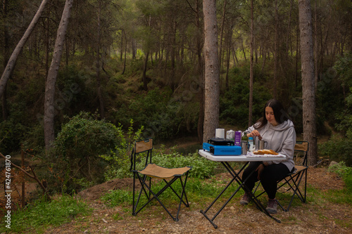 Girl on a camping trip having a glass of milk.