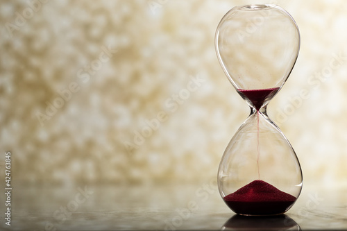 Hourglass as a concept of passing time for business deadline, urgency and outcome of time.