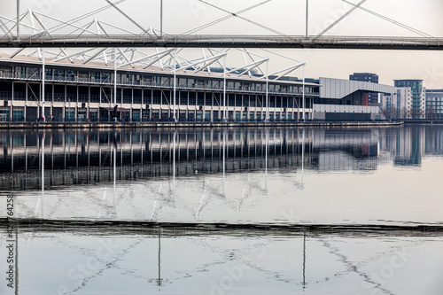 The Royal Victoria Docks in London reflected in the water.