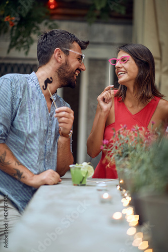 A couple having fun at the open air birthday party. Quality friendship time together photo