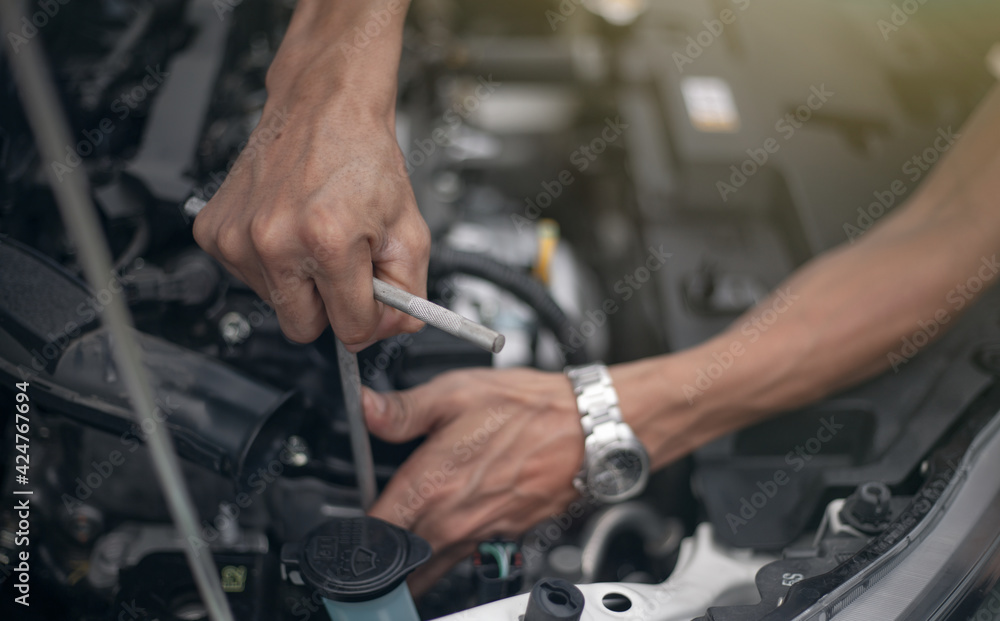 Auto mechanic working and repair on car engine in mechanics garage. Car service. Auto mechanic working and repair on car engine in mechanics garage. Car service.