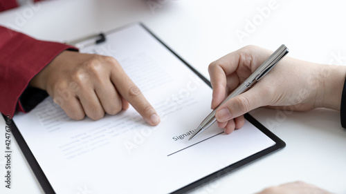 Signing a home purchase contract, sales manager has proposed terms and conditions to customers who sign house purchase agreements with insurance, Agreement to sign the purchase contract concept.