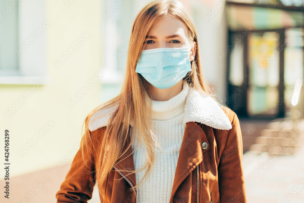 Portrait of a young woman wearing a mask outdoors during the COVID-19 pandemic Portrait of a young woman wearing a mask outdoors during the COVID-19 pandemic