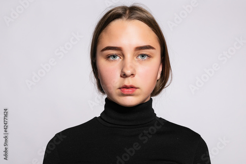 Trendy beautiful hipster girl. Photo of positive young nice woman in black knee-high socks with white background. looking at the camera and serious