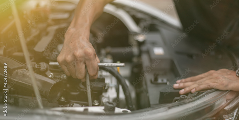 Auto mechanic working and repair on car engine in mechanics garage. Car service. Auto mechanic working and repair on car engine in mechanics garage. Car service.