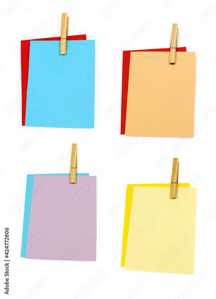 colorful writing paper held together with a clothespin with room for text on a white background colorful writing paper held together with a clothespin with room for text on a white background