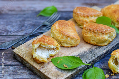 Fresh baked home made Mini cheese puff pastries.Cheese pie with phyllo pastry and herbs