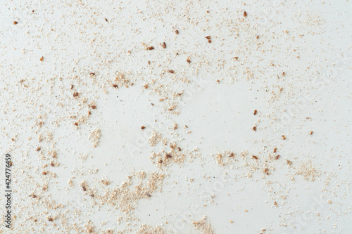 Flour texture with seeds. White surface.