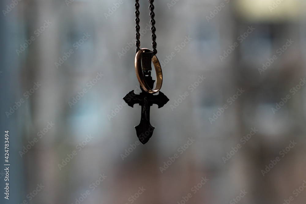 silver chain and cross, close-up with blurred background silver chain and cross, close-up with blurred background