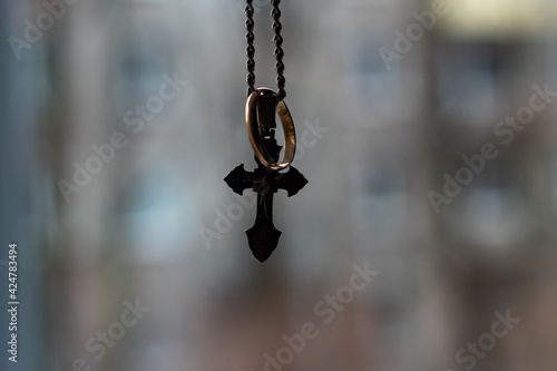 silver chain and cross, close-up with blurred background