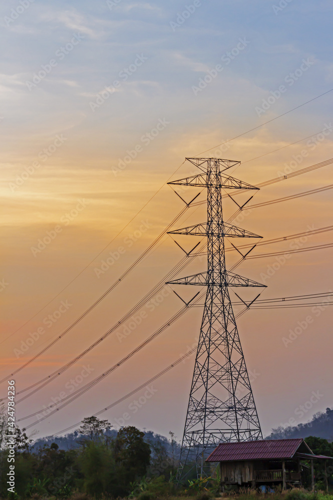 Fototapeta premium High voltage electricity poles at sunset