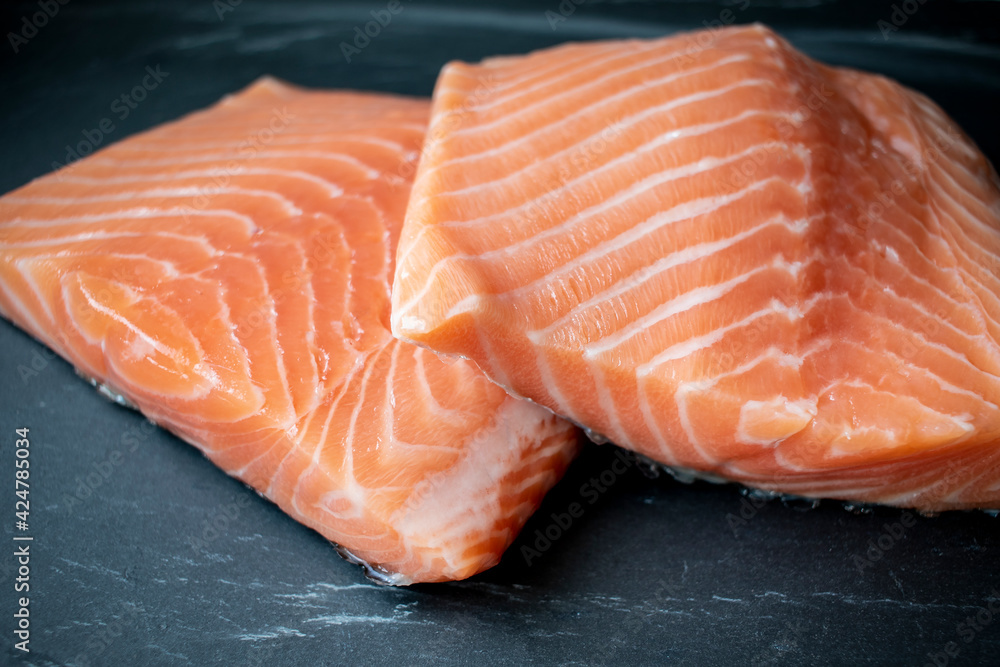 Fresh Salmon fillet on black stone background Fresh Salmon fillet on black stone background