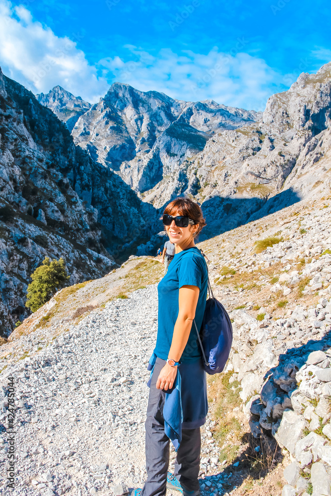 A young woman on the trail in the Picos de Europa, on the Cares route. Asturias A young woman on the trail in the Picos de Europa, on the Cares route. Asturias