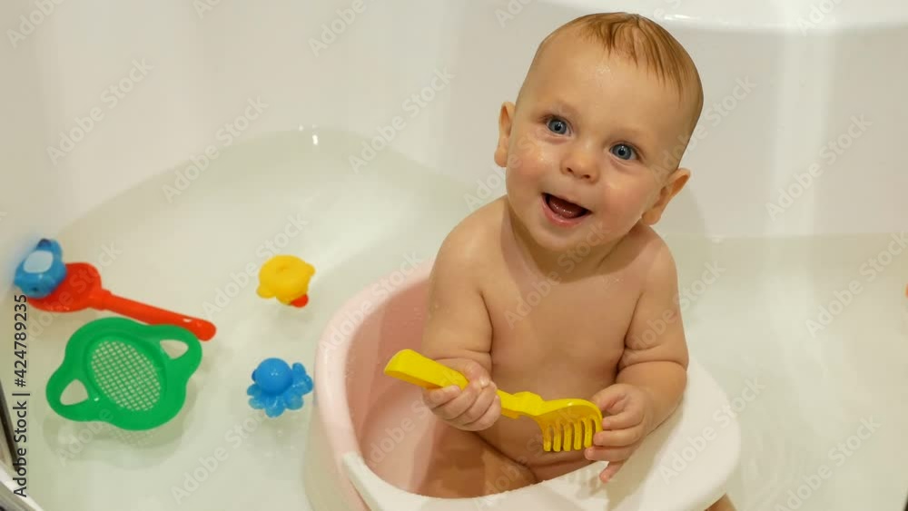 Mother washing her little son in bathroom. Mother washing her little son in bathroom.