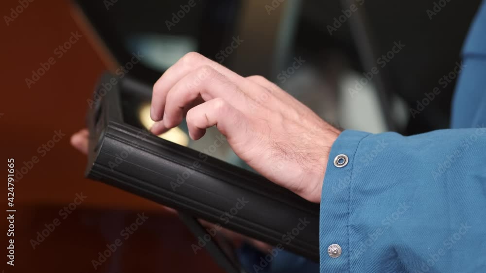 Mechanic uses a tablet at the car service Mechanic uses a tablet at the car service