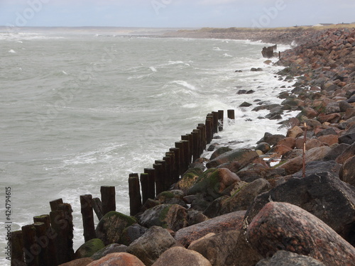 Coastline with Silent Water and breakwater Rocks