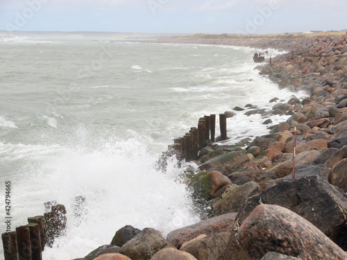 Crashing waves against black rocks at coast