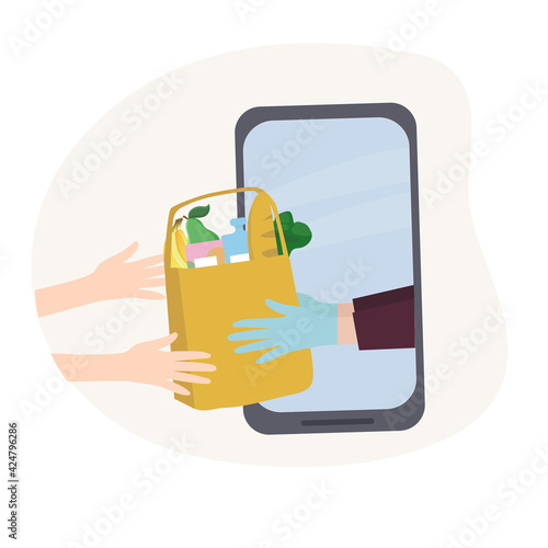 The concept of safe home delivery. The courier holds the package with the goods, hands the customer a fast food. Online store of goods, ordering over the Internet and delivery to the door of the home