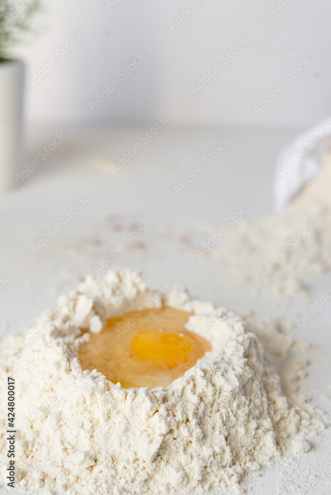 Raw chicken Organic Brown free range eggs Farm pack on white table Flour basket , egg yolk Raw chicken Organic Brown free range eggs Farm pack on white table Flour basket , egg yolk