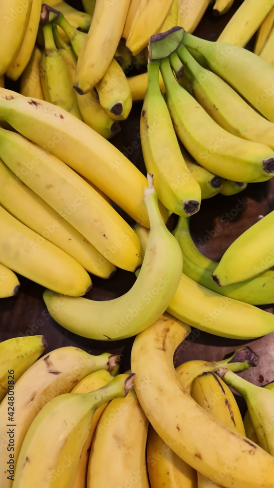 Yellow and little green banana in supermarket Yellow and little green banana in supermarket