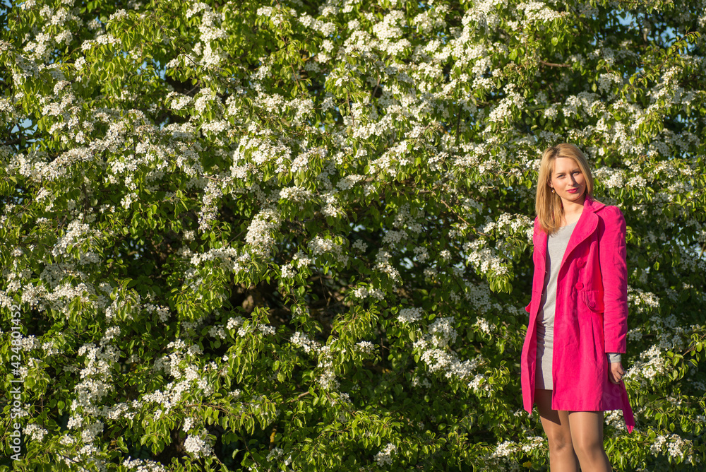 Young beautiful woman in a blooming gardens Young beautiful woman in a blooming gardens