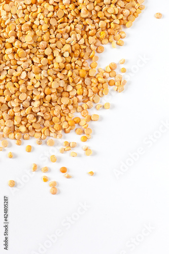Yellow split peas on white in studio.