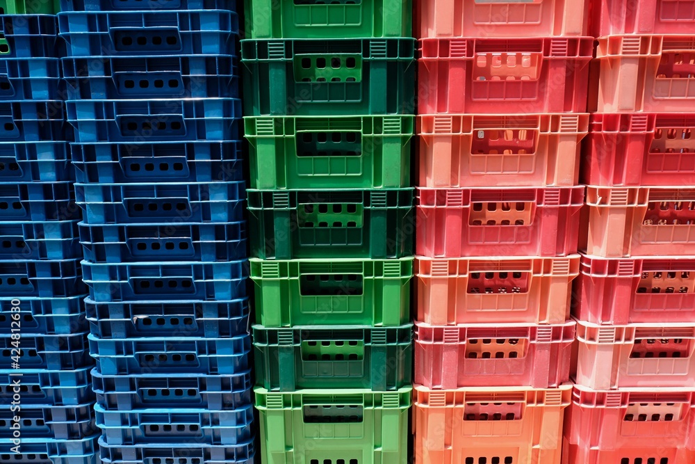 Stacked multi-colored old plastic baskets background Stacked multi-colored old plastic baskets background