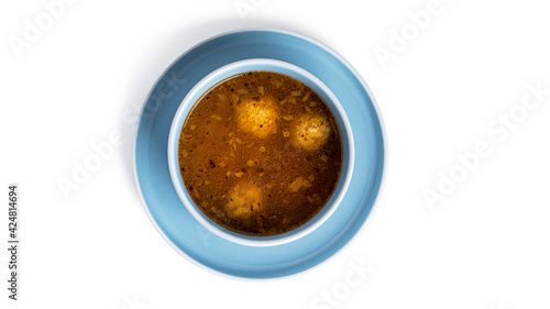 Soup with meatballs in white deep dish isolated on a white background.