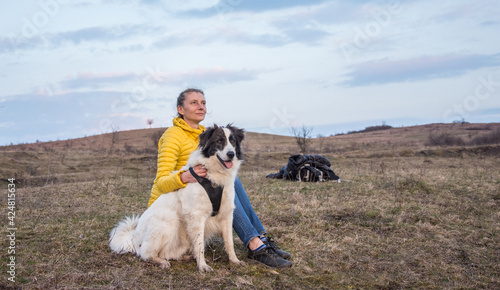 Woman and dog enjoying outdoors on a green field