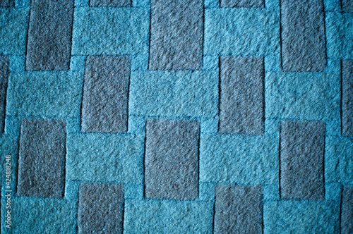 Background, texture, design. Blue and brown rectangles on woolen fabric.