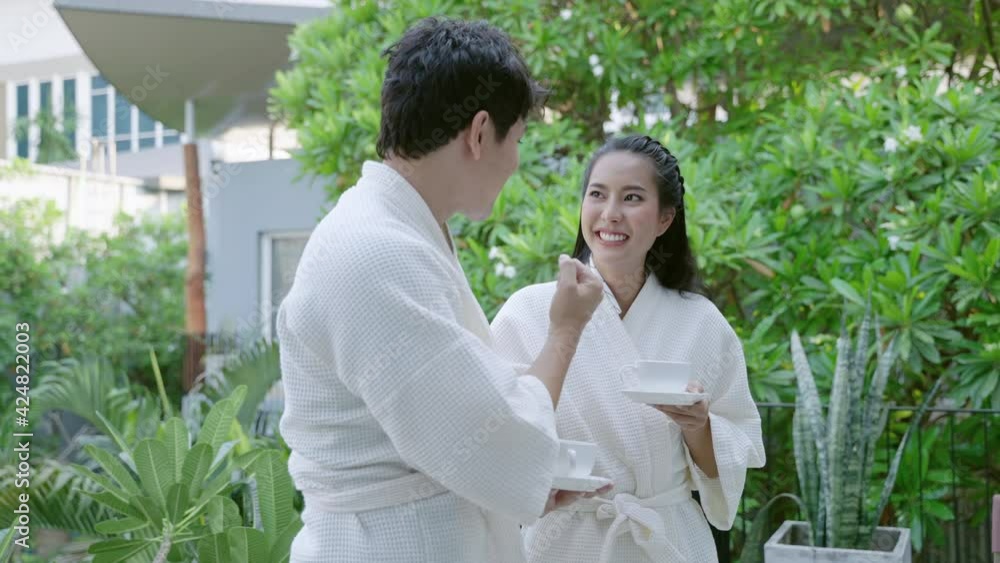 Couple sipping coffee on the balcony of the hotel room on vacation
