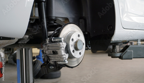 Disc brakes of a modern car. Brake disc, brake caliper. Maintenance and repair of a modern car. Spare parts.