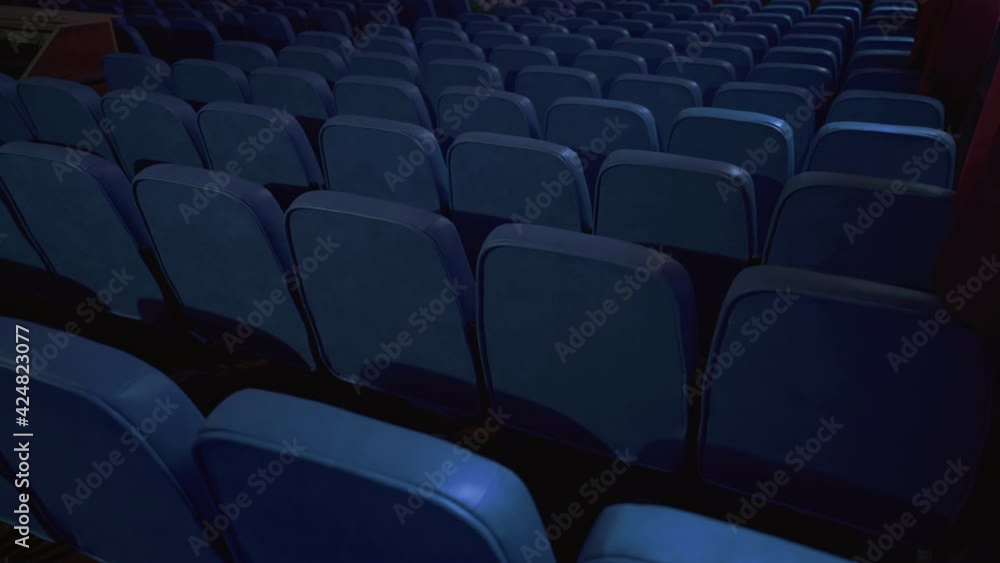 Empty cinema. Film premiere without spectators. Movie spotlight. Blue chairs, chairs with no movie fans. Cinema projector. World crisis, financial losses, consequences of the pandemic.
Empty cinema. Film premiere without spectators. Movie spotlight. Blue chairs, chairs with no movie fans. Cinema projector. World crisis, financial losses, consequences of the pandemic.