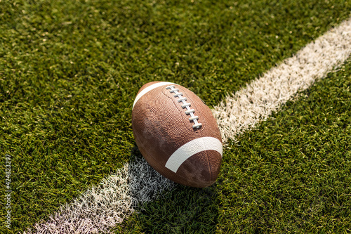 American rugby ball on the grass in the stadium photo