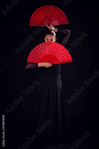 flamenco woman with black dress and fans on her face