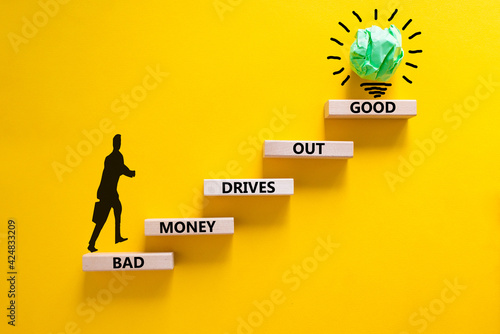 Business concept growth success process. Wood blocks stacking as step stair on yellow background, copy space. Businessman icon. Words 'bad money drives out good'. Conceptual image of motivation.