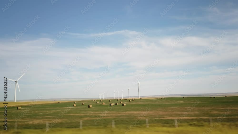Slow Motion Summer Driving Scenery Across Wind Farm in Alberta Slow Motion Summer Driving Scenery Across Wind Farm in Alberta