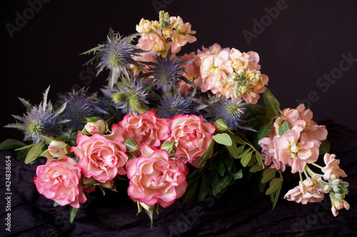 Bouquet of flowers, pink roses, pink matthiola and blue thistles