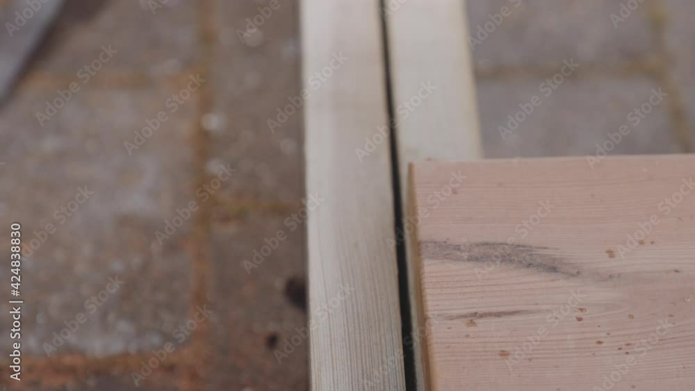 Carpenter Placing Wood On Decking Carpenter Placing Wood On Decking