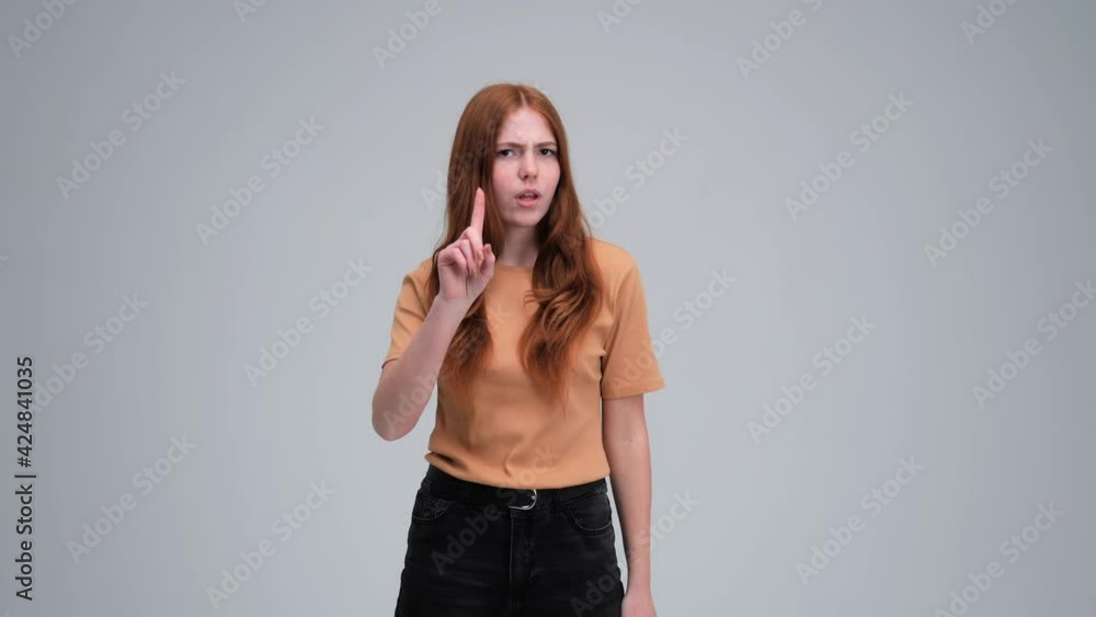 Confused ginger girl disagree pointing finger at herself saying no shaking head, misunderstanding in communication. indoor studio shot isolated on white background shocked concerned. Confused ginger girl disagree pointing finger at herself saying no shaking head, misunderstanding in communication. indoor studio shot isolated on white background shocked concerned.