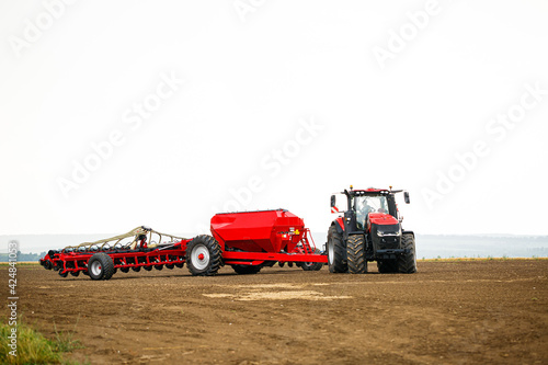 Fototapeta Naklejka Na Ścianę i Meble -  Large modern tractor for preparing the field after winter for sowing grain. Agricultural machinery