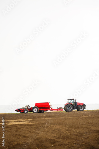 Large modern tractor for preparing the field after winter for sowing grain. Agricultural machinery © Дмитрий Ткачук